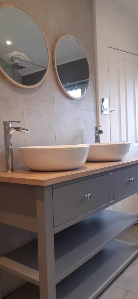Two wash basins placed with a mirror on top of each - Bathroom refurbishment by Jikka