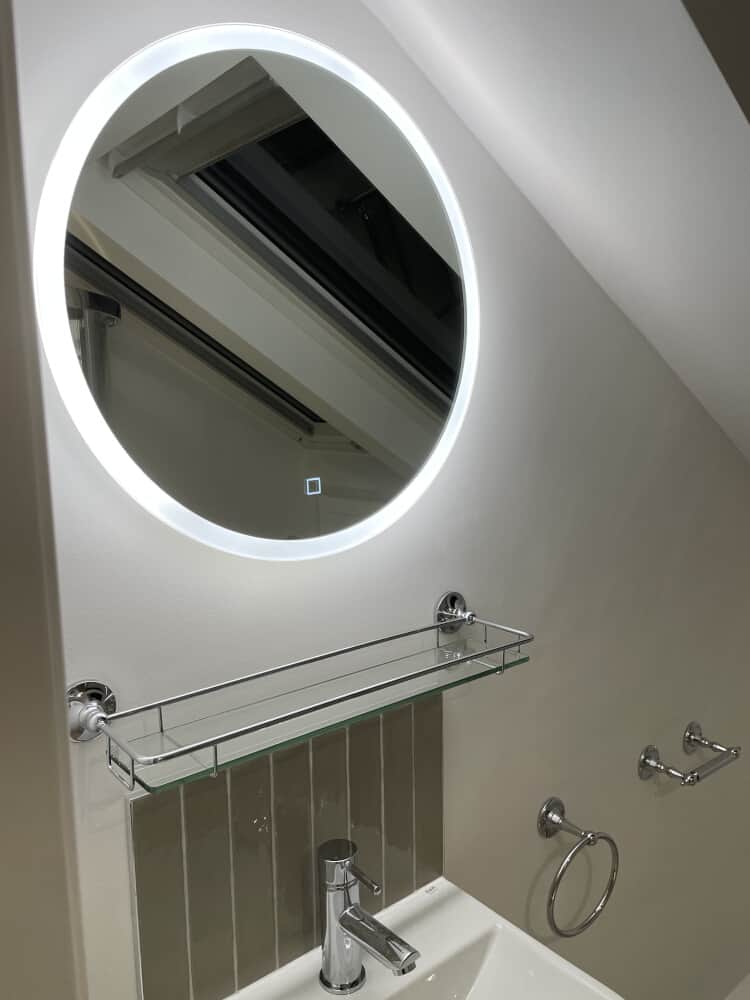 Wash basin with a glass rack and mirror above it by Jikka - Bathroom refurbishment
