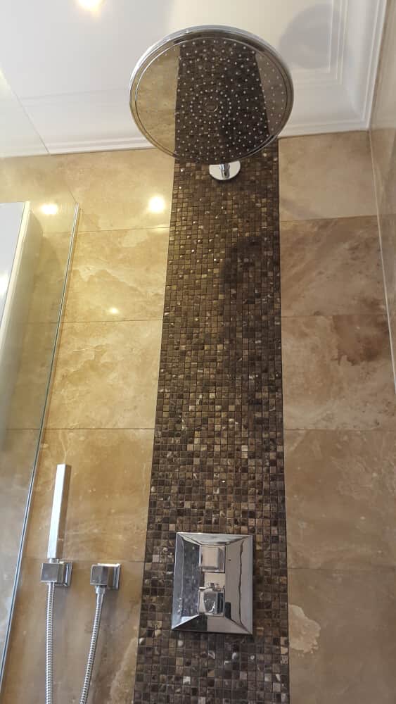 Modern style shower with tap and jet spray beneath it by Jikka - Bromley Bathroom Company