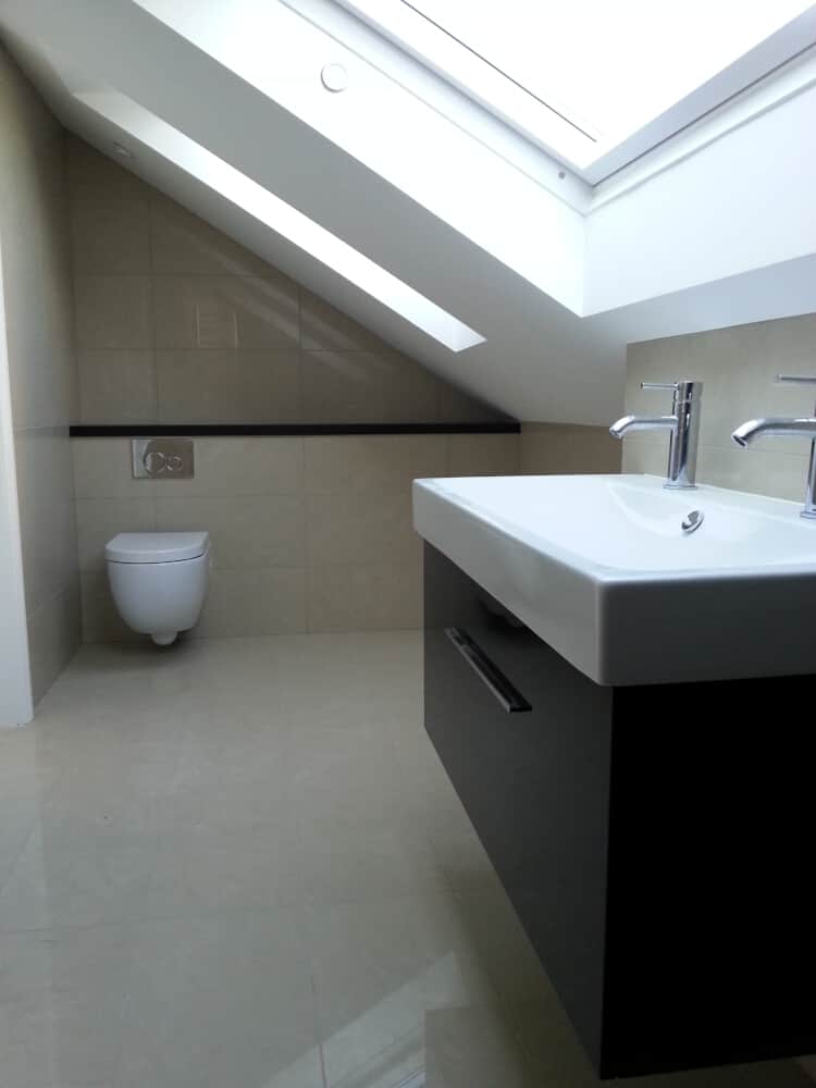 Wall mounted wash basin with two taps and a water closet by its side - Bathroom shops in Bromley