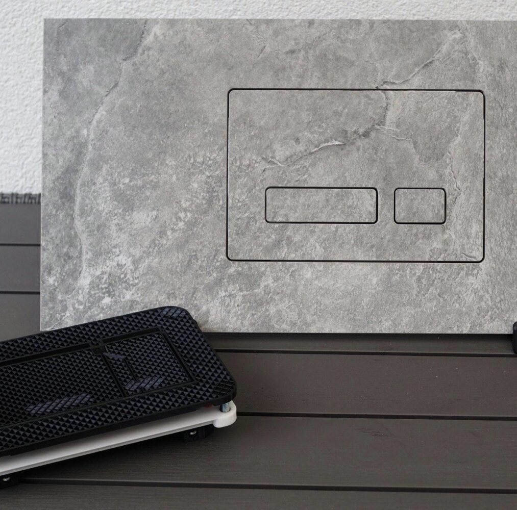 Tile-clad concealed flush plate blending into the wall